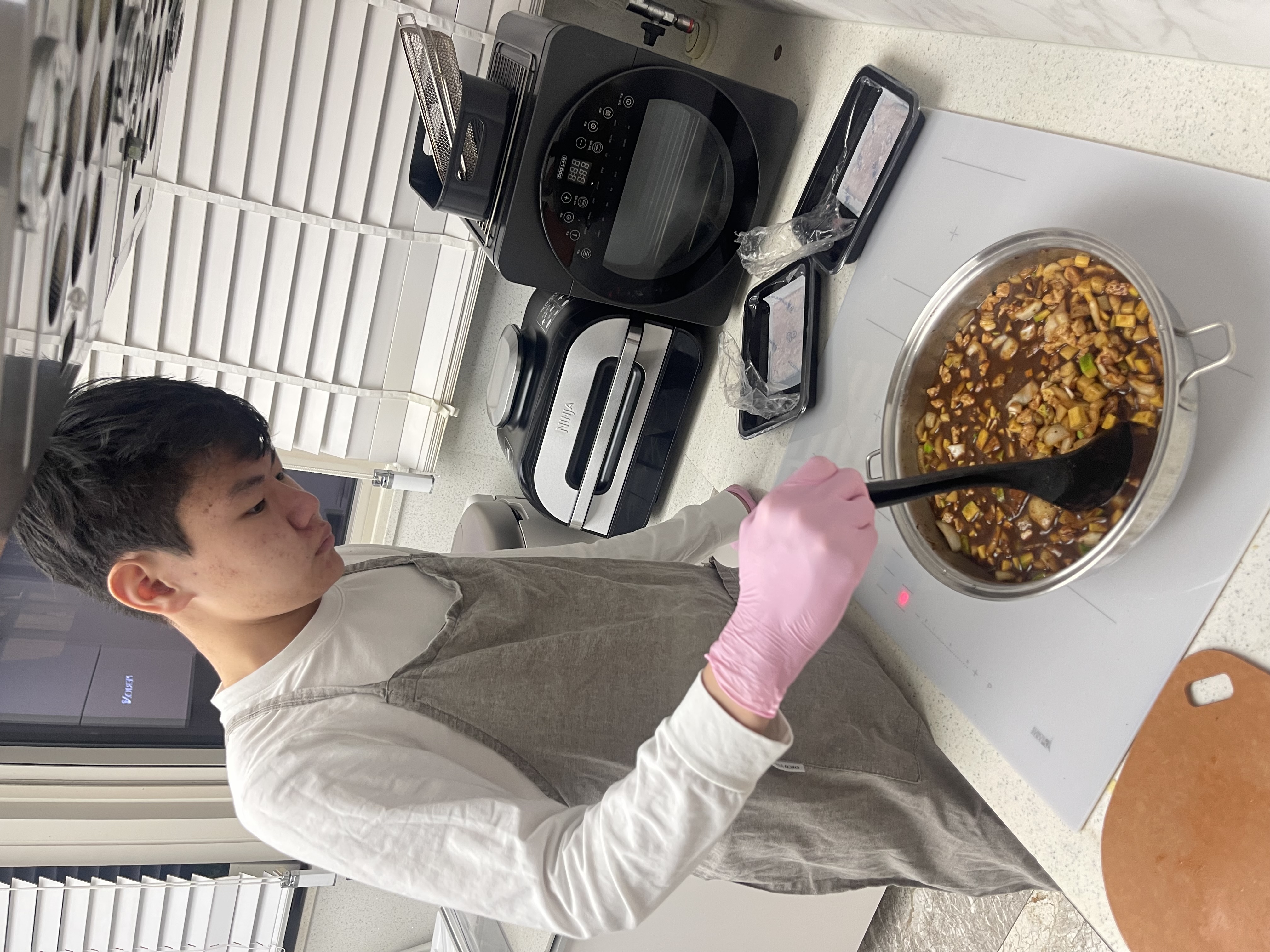 Dongwook cooking or preparing food for charity.